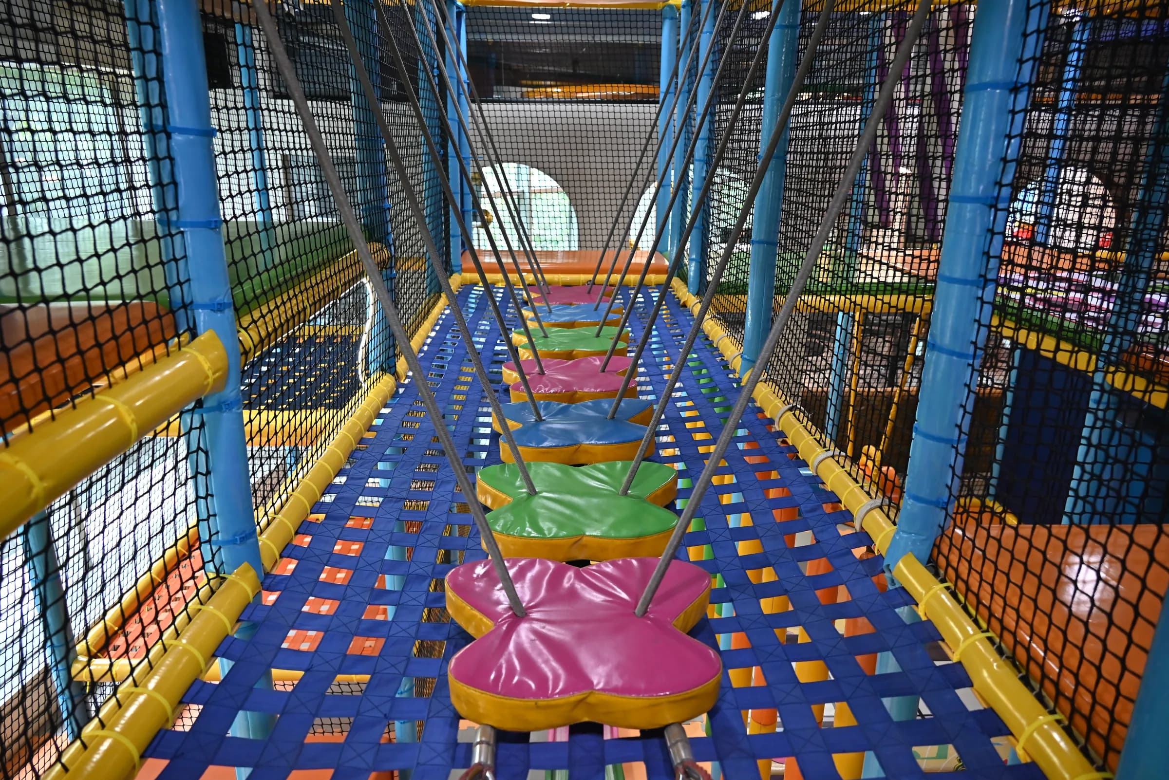 Colourful soft-play obstacle bridge at Lopa Playzone & Banquet