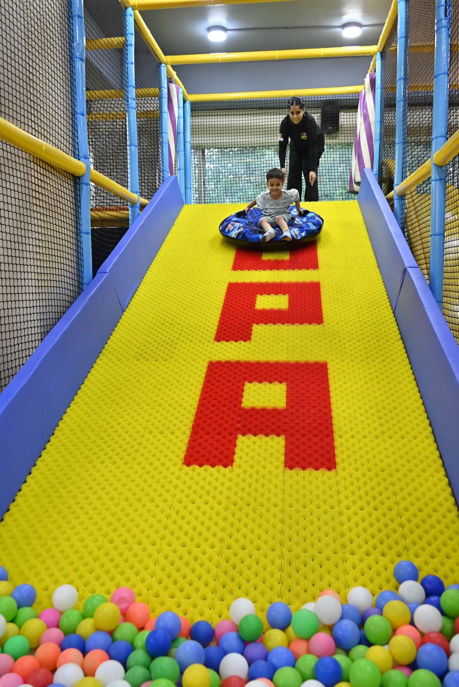 Child playing safely with a Lopa team member nearby