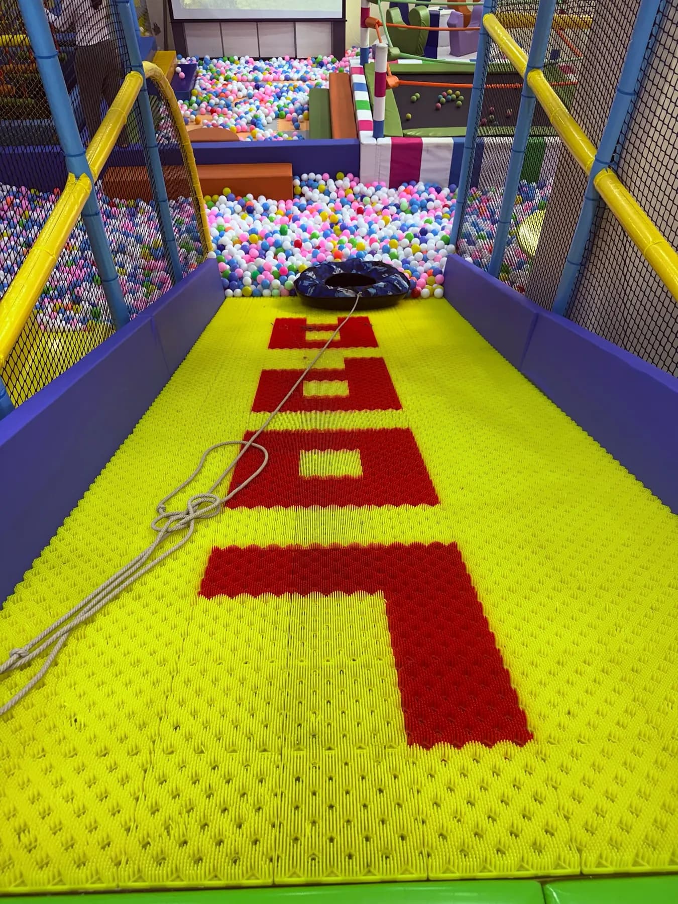 The wide yellow Lopa slide dropping into the ball pool