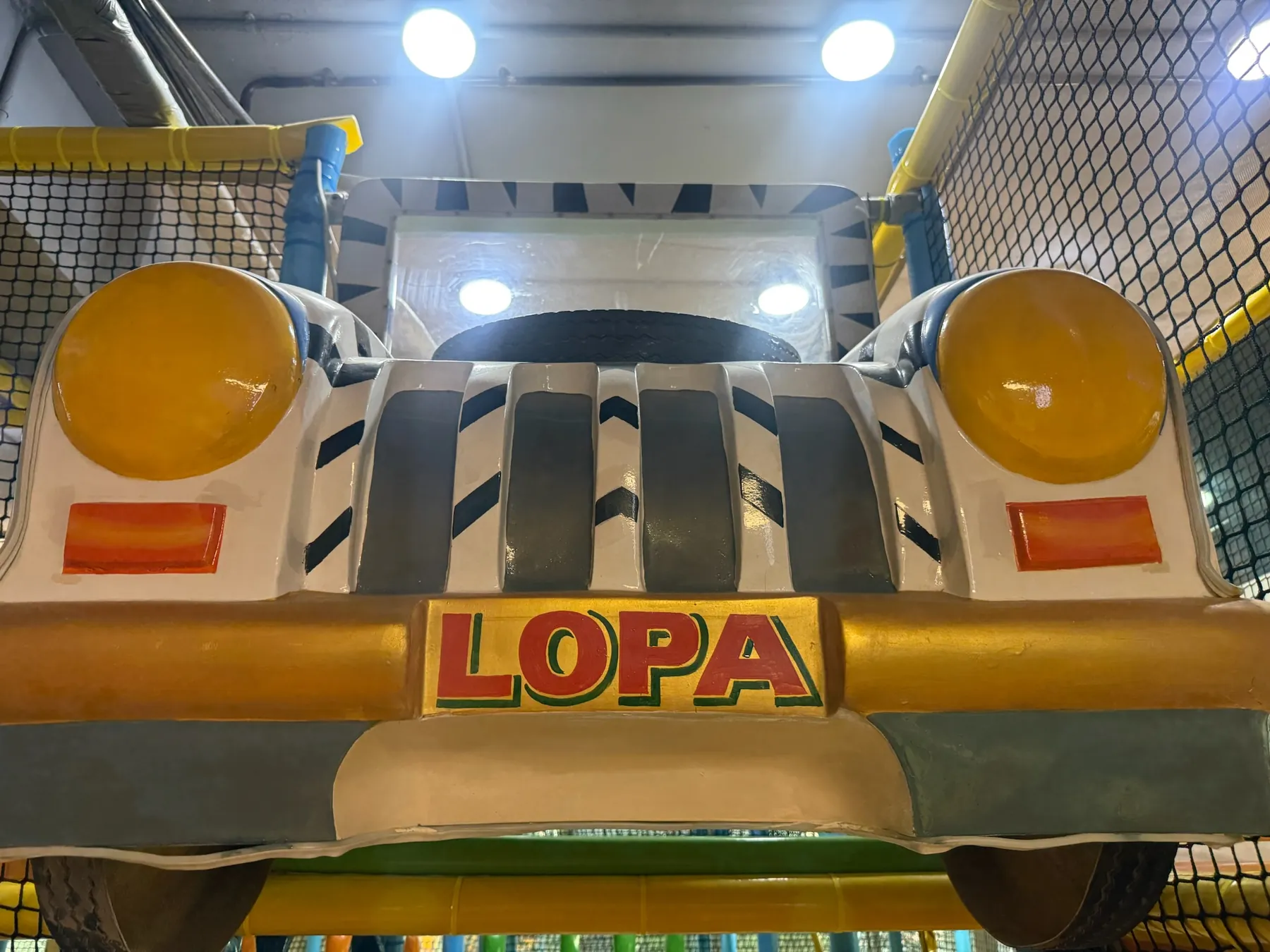Zebra striped ride-on car in the Lopa play zone