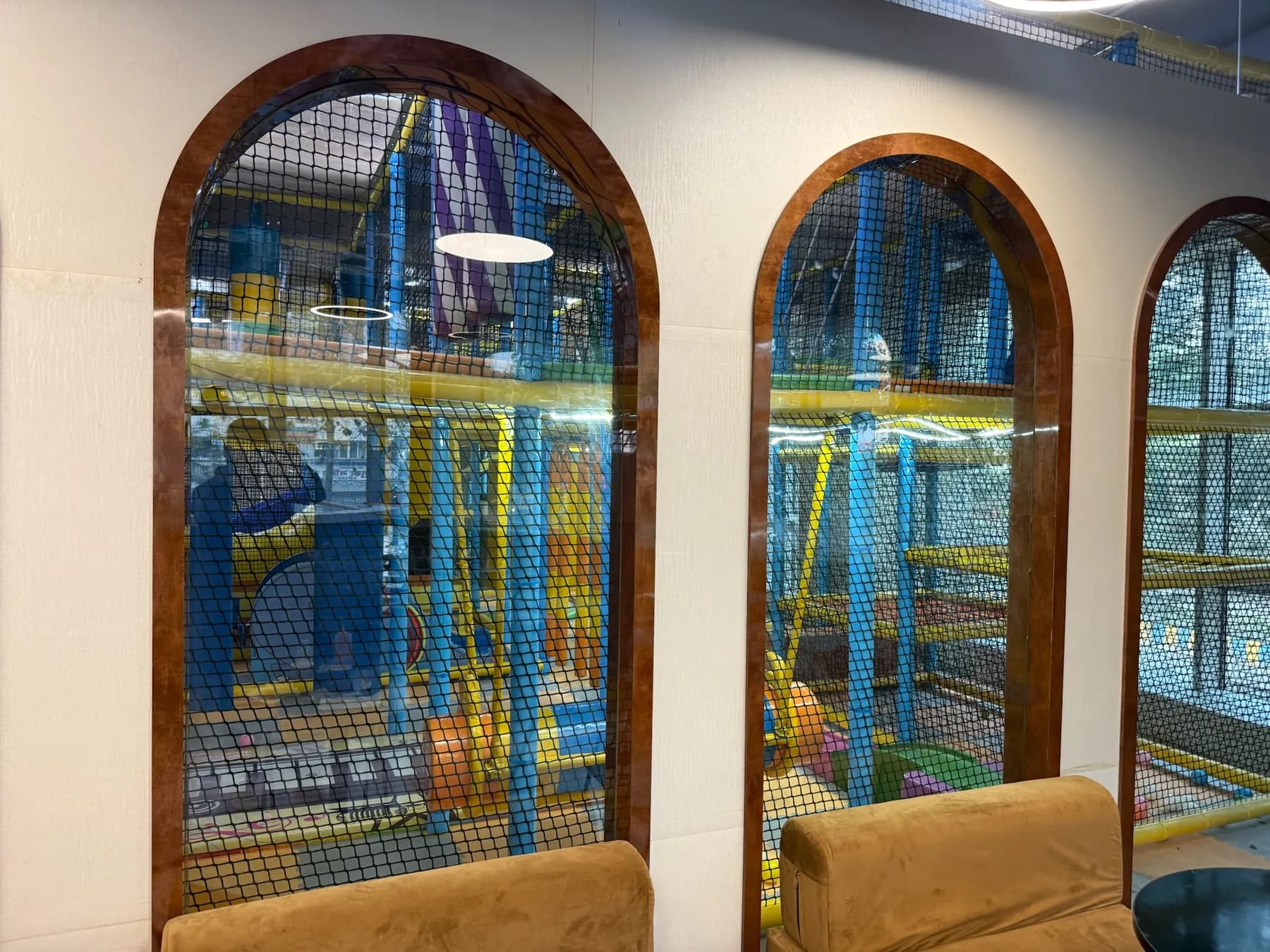 Arched windows looking through from the cafe into the play area